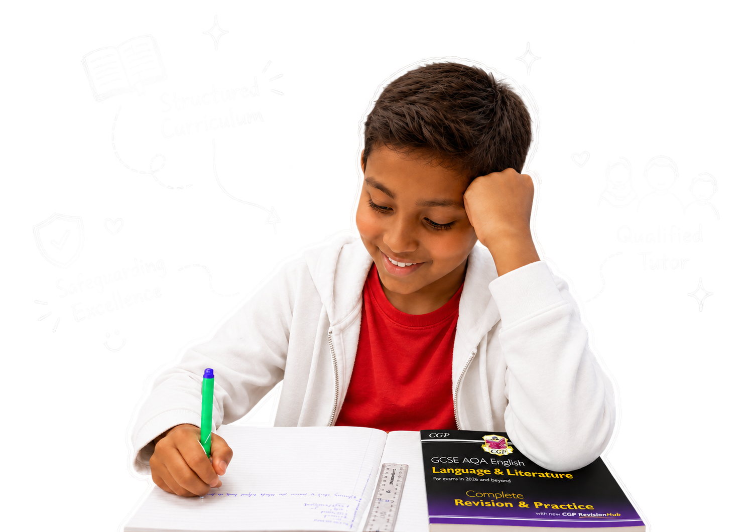 A boy smiling as he writes in his exercise book